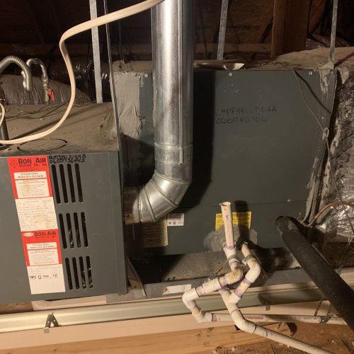 A heating unit being tuned up for optimal function